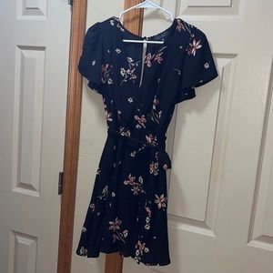 Black dress with small flower design. Tie waist detail and ruffle sleeves Size S